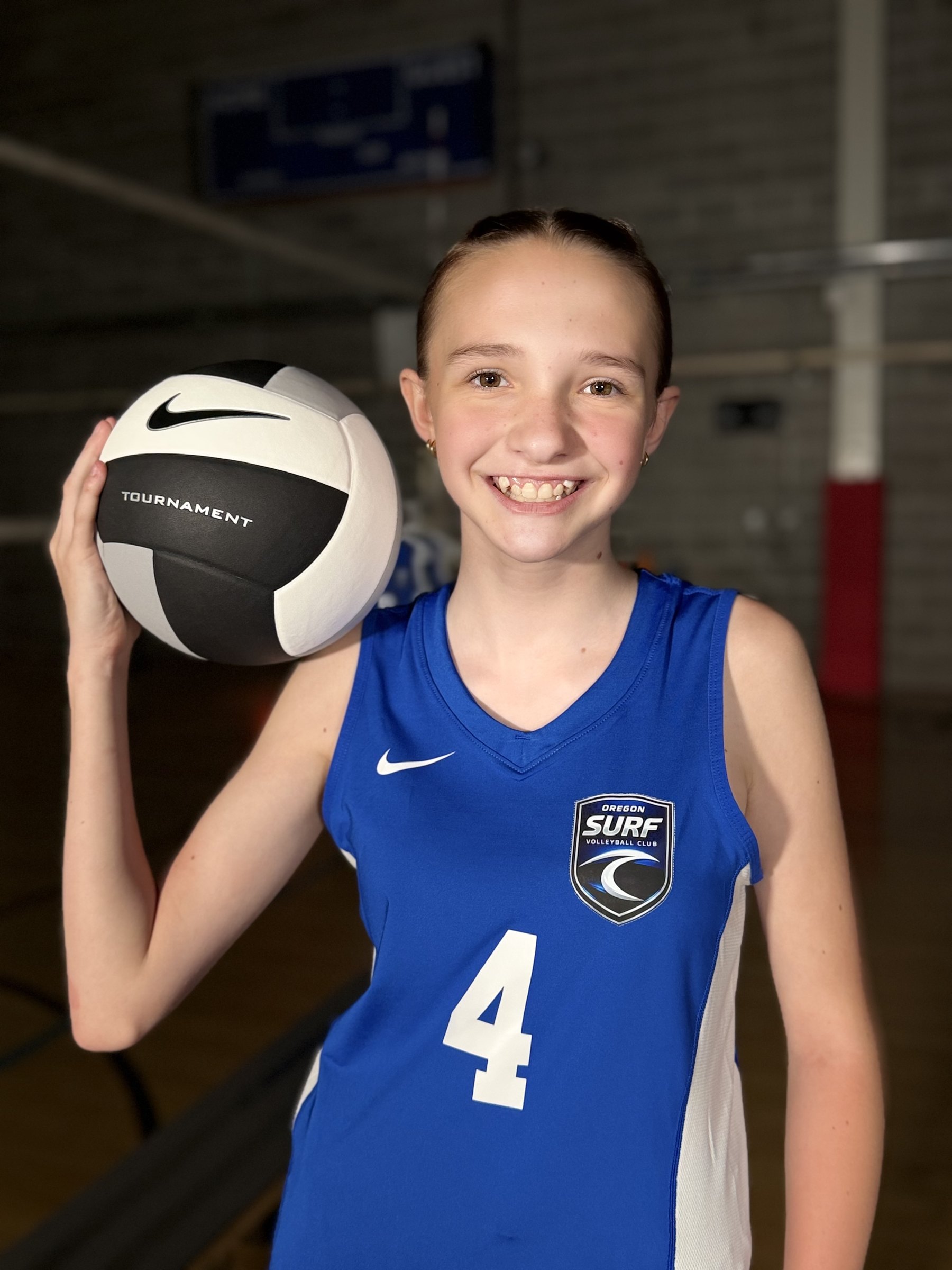 A smiling Oregon Surf player with a volleyball